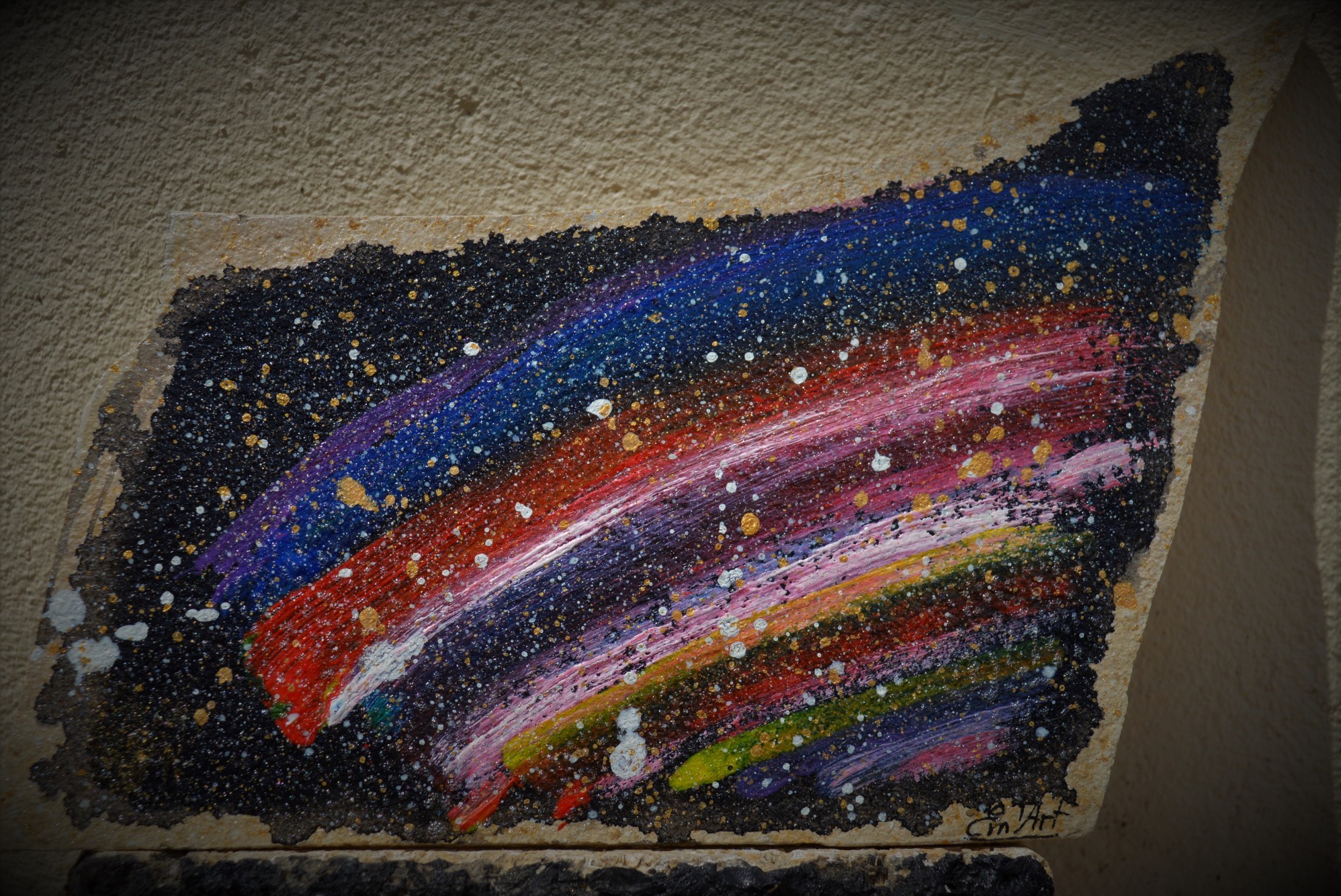 Cosmic rainbow painting on flat stone by Emmanuelle Baudry